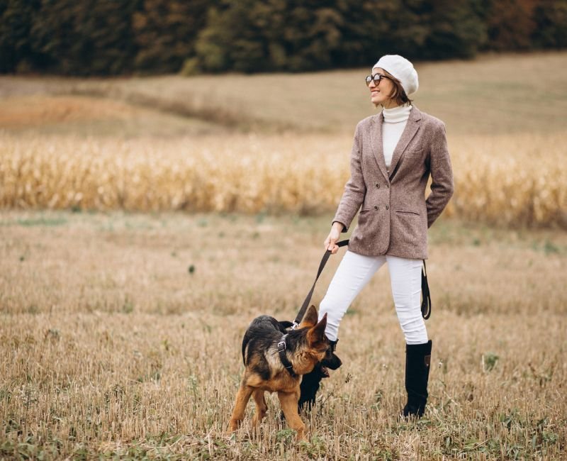 Woman walking a German Shepherd
